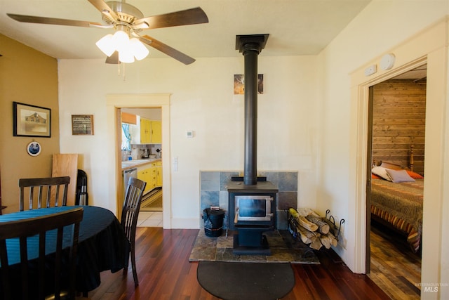 599 S Ada St, Glenns Ferry, ID 83623 - living area featuring a wood stove, dark wood finished floors, and ceiling fan