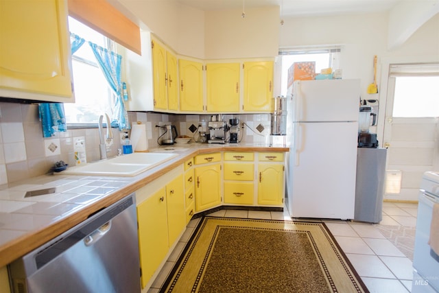 599 S Ada St, Glenns Ferry, ID 83623 - kitchen with dishwasher, freestanding refrigerator, a sink, and healthy amount of natural light