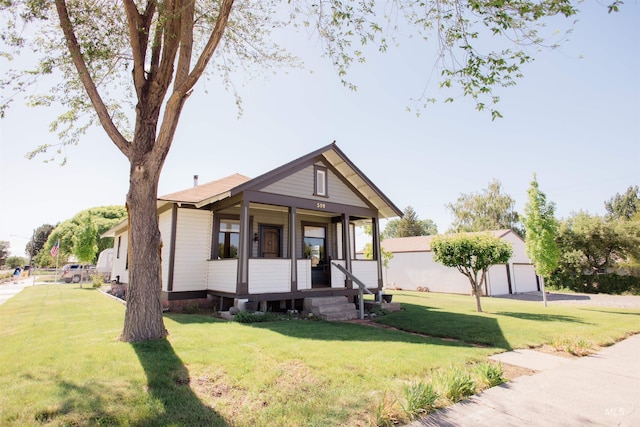 599 S Ada St, Glenns Ferry, ID 83623 - view of front of home with covered porch, a front yard, and a garage
