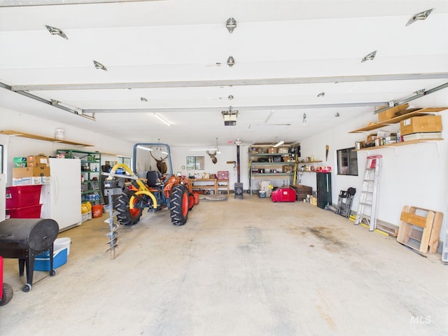 19 Hack Ln, Idaho City, ID 83631 - garage featuring freestanding refrigerator and a garage door opener