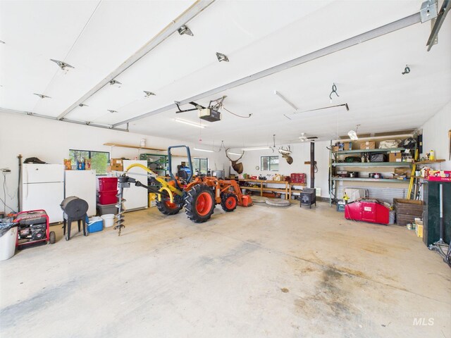 19 Hack Ln, Idaho City, ID 83631 - garage with freestanding refrigerator and a garage door opener