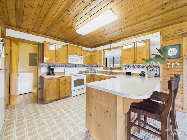 19 Hack Ln, Idaho City, ID 83631 - kitchen featuring white appliances, a peninsula, light countertops, light flooring, and a kitchen breakfast bar