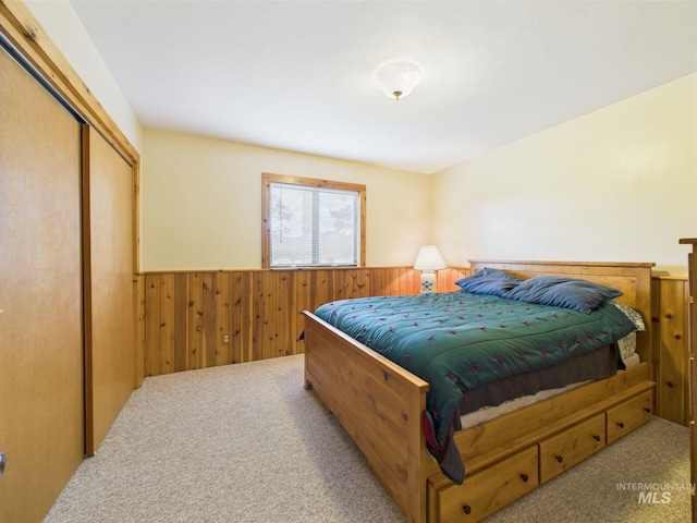 19 Hack Ln, Idaho City, ID 83631 - carpeted bedroom featuring wainscoting, a closet, and wood walls