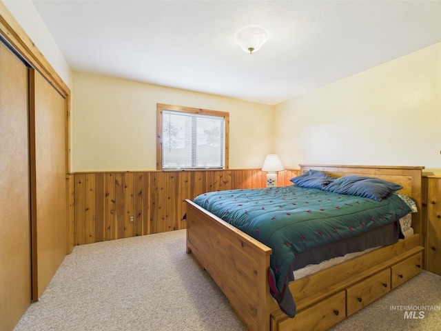 19 Hack Ln, Idaho City, ID 83631 - bedroom with a wainscoted wall, carpet floors, wooden walls, and a closet