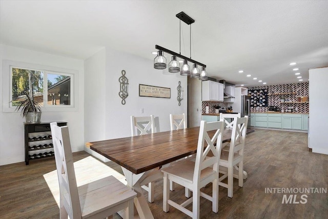 dining room with a chandelier and dark wood-type flooring