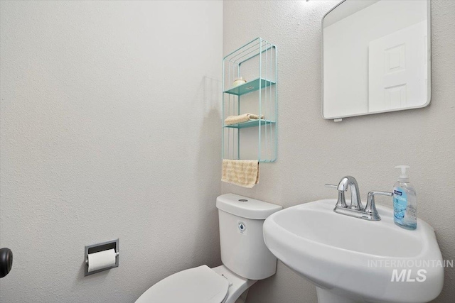 bathroom featuring sink and toilet