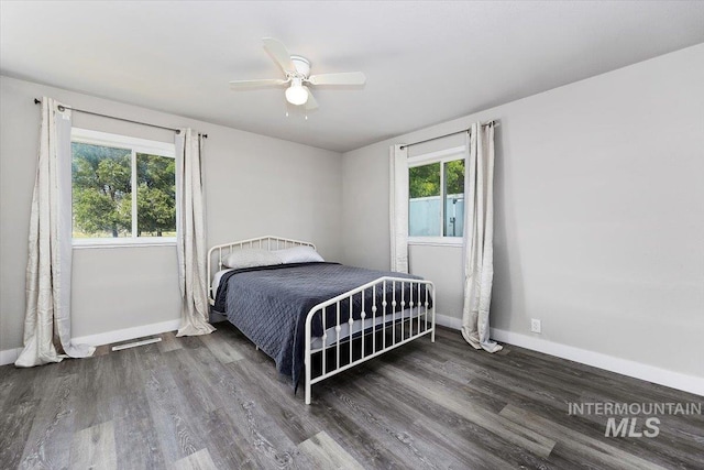 bedroom with ceiling fan and dark hardwood / wood-style flooring