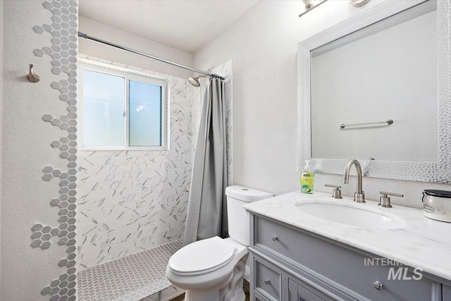 bathroom with walk in shower, vanity, and toilet