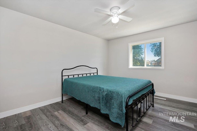 bedroom featuring ceiling fan and dark wood-type flooring