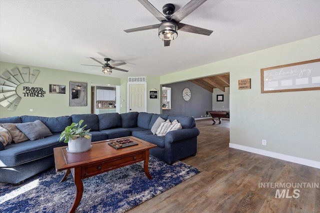 living room featuring wood-type flooring, a textured ceiling, beam ceiling, billiards, and ceiling fan