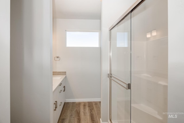 bathroom with vanity, wood-type flooring, and walk in shower