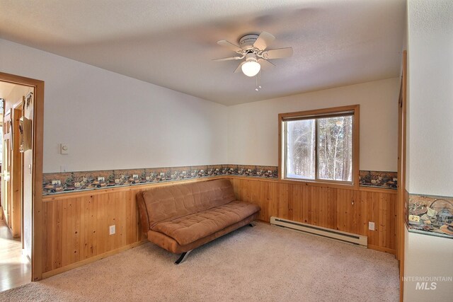 14187 Hancock Rd, Mccall, ID 83638 - sitting room with baseboard heating, carpet floors, wooden walls, and a wainscoted wall