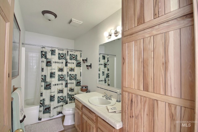 full bathroom featuring vanity, toilet, and shower / bath combo with shower curtain