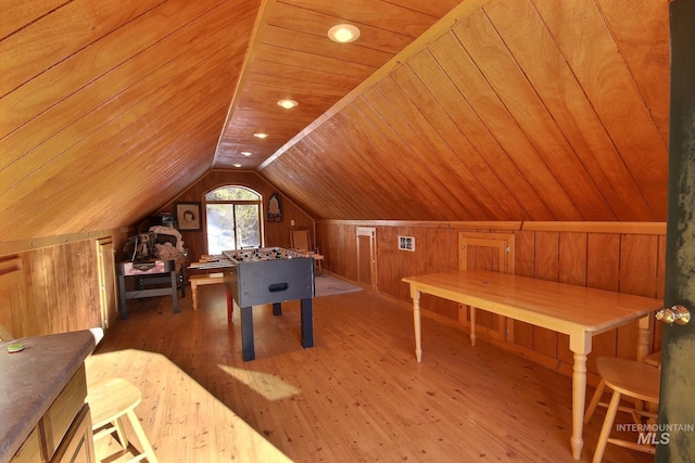 rec room featuring lofted ceiling, wooden ceiling, wooden walls, and light hardwood / wood-style flooring