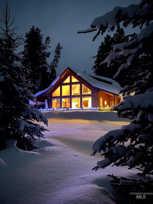 view of snow covered back of property