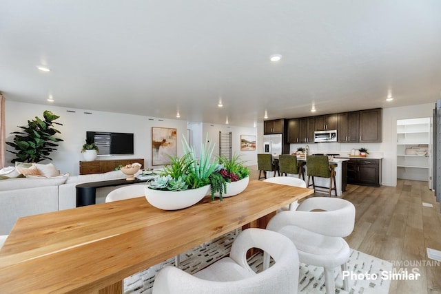 dining room featuring light wood-style flooring and recessed lighting
