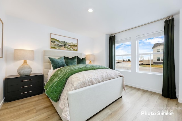 bedroom featuring recessed lighting, light wood-style floors, and baseboards