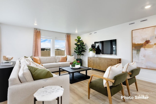 living room featuring recessed lighting, visible vents, and light wood-type flooring