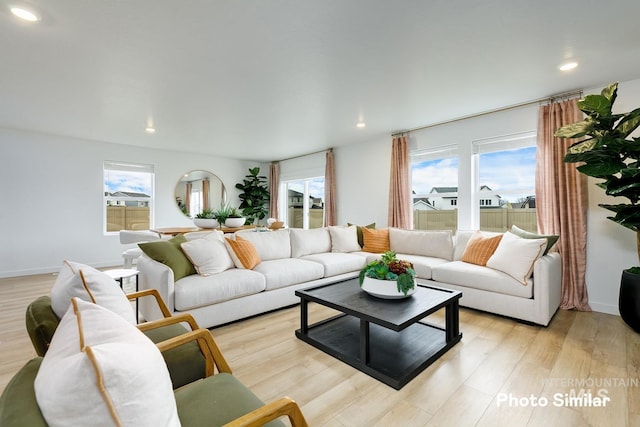 living room featuring light wood-style flooring and recessed lighting