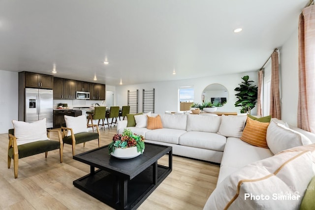 living area featuring recessed lighting and light wood-style floors