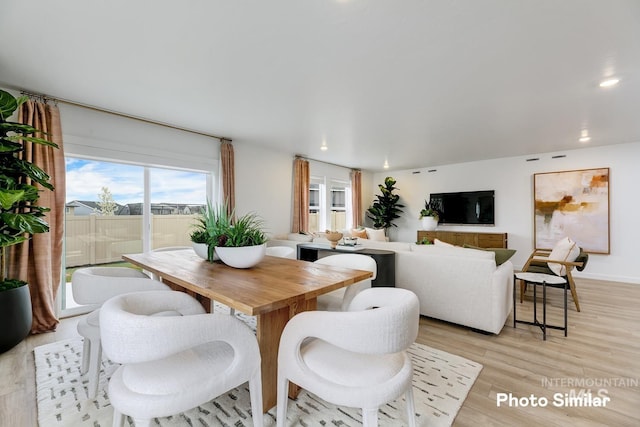 dining room with baseboards, recessed lighting, and light wood-style floors