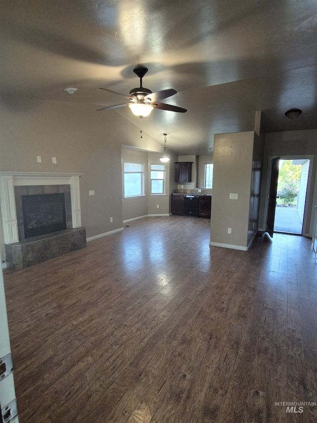 400 Pheasant Rd W, Twin Falls, ID 83301 - unfurnished living room featuring dark wood finished floors, ceiling fan, lofted ceiling, and a tiled fireplace