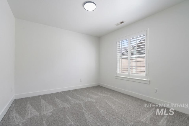 unfurnished room featuring carpet floors and baseboards
