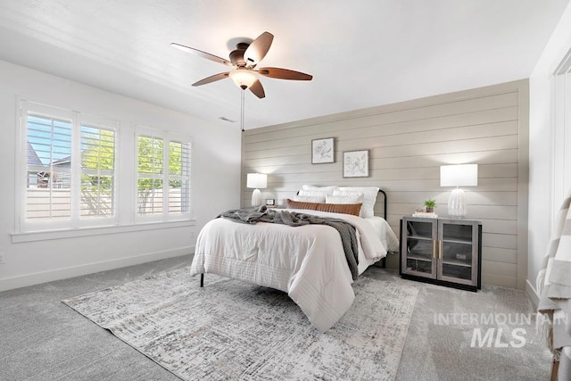 carpeted bedroom with baseboards and a ceiling fan