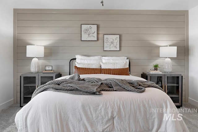 carpeted bedroom featuring baseboards
