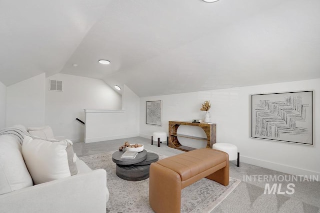 living room featuring vaulted ceiling and baseboards