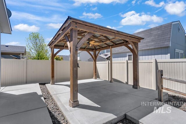 view of patio / terrace featuring a gazebo, a detached carport, and a fenced backyard