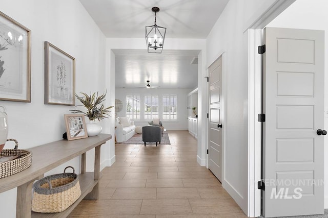 hall featuring a chandelier and light wood-style flooring