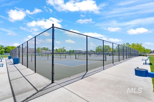 view of tennis court featuring fence