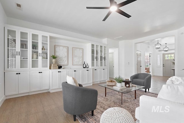 living area with ceiling fan