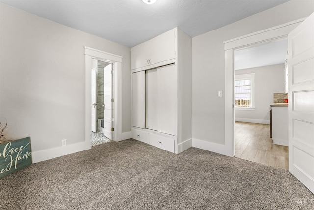 unfurnished bedroom featuring a closet and light hardwood / wood-style flooring