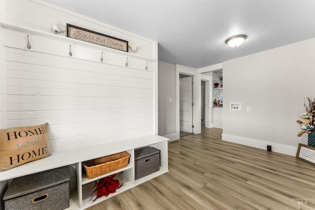 mudroom with hardwood / wood-style flooring and a textured ceiling