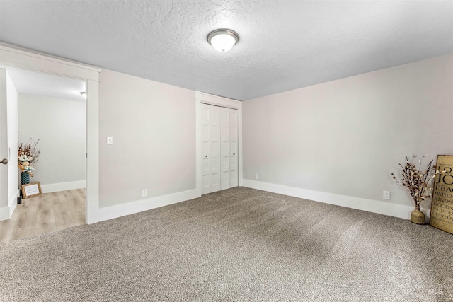 carpeted spare room featuring a textured ceiling