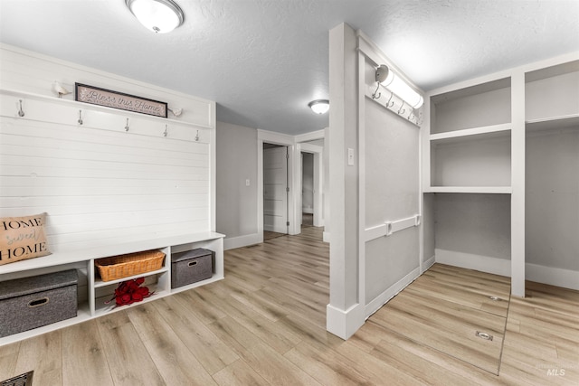 mudroom featuring light hardwood / wood-style floors and a textured ceiling