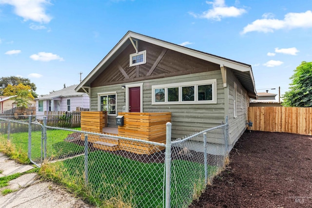 bungalow-style house with a front lawn