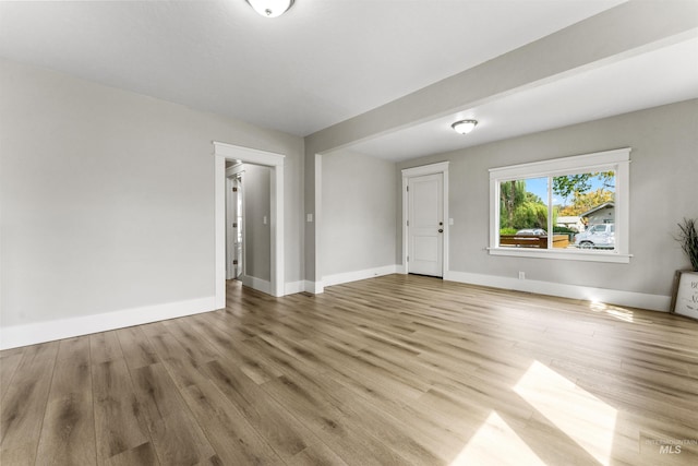 unfurnished room with wood-type flooring