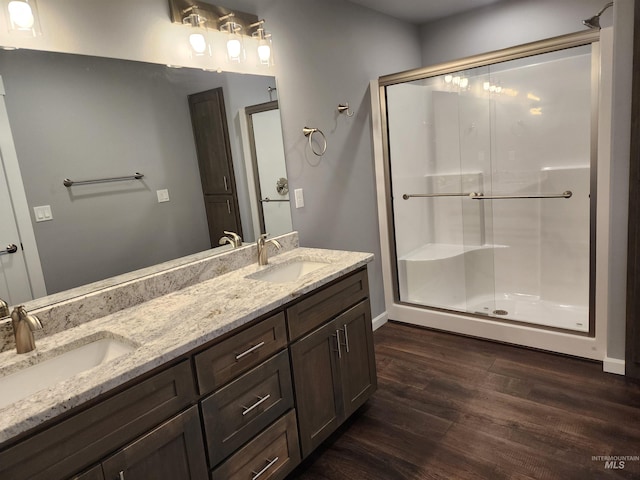 bathroom featuring hardwood / wood-style flooring, vanity, and an enclosed shower