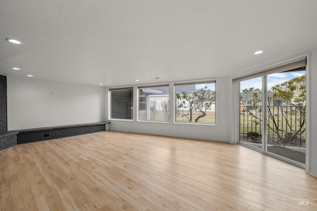 unfurnished living room with light hardwood / wood-style flooring