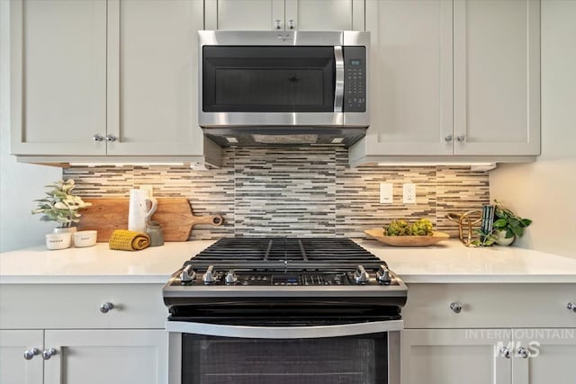 2381 E Warm Spgs, Boise, ID 83712 - kitchen with appliances with stainless steel finishes, light countertops, tasteful backsplash, and white cabinetry