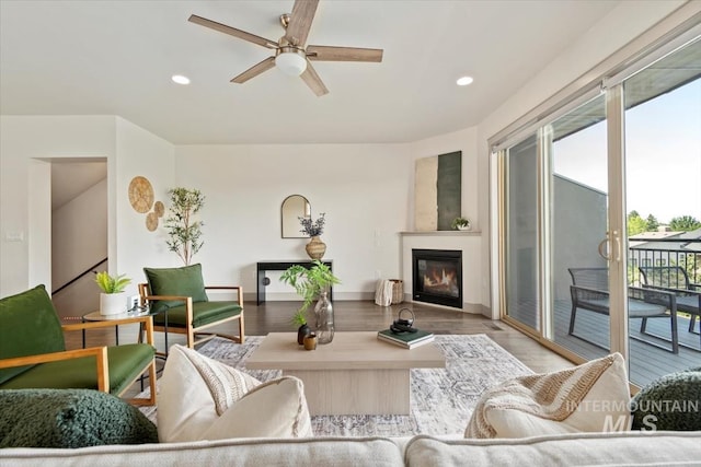 2381 E Warm Spgs, Boise, ID 83712 - living room with healthy amount of natural light, a ceiling fan, recessed lighting, a glass covered fireplace, and wood finished floors