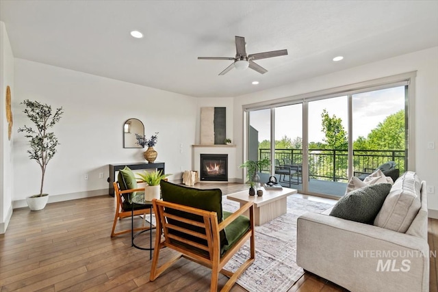 2381 E Warm Spgs, Boise, ID 83712 - living area with a glass covered fireplace, recessed lighting, hardwood / wood-style floors, a ceiling fan, and baseboards
