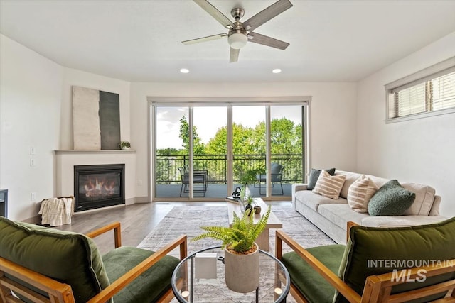 2381 E Warm Spgs, Boise, ID 83712 - living area with a glass covered fireplace, recessed lighting, wood finished floors, and ceiling fan