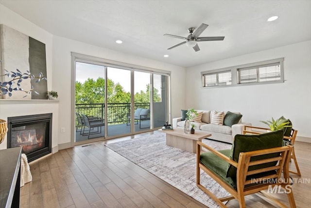 2381 E Warm Spgs, Boise, ID 83712 - living area with a glass covered fireplace, a ceiling fan, recessed lighting, wood finished floors, and baseboards