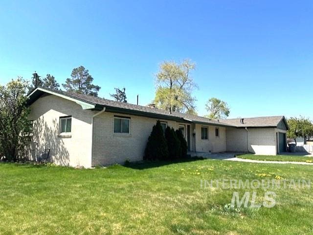 995 E 15th N, Mountain Home, ID 83647 - back of property featuring a yard and brick siding