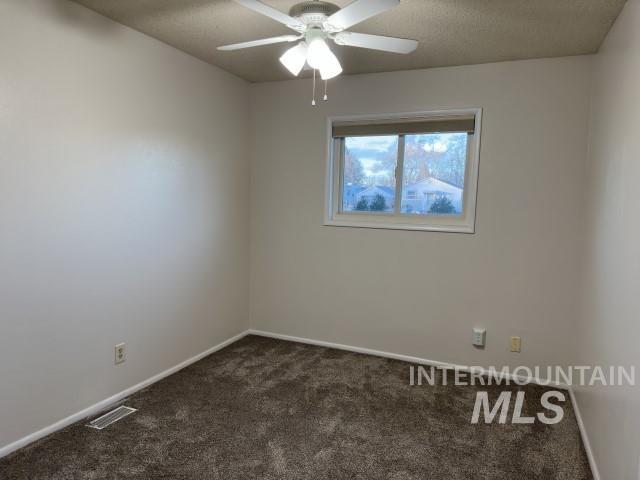 995 E 15th N, Mountain Home, ID 83647 - unfurnished room with carpet floors, baseboards, ceiling fan, and visible vents