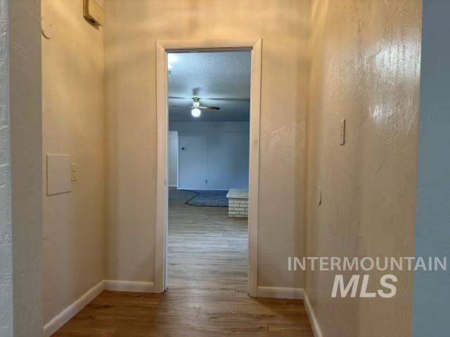 995 E 15th N, Mountain Home, ID 83647 - hallway with baseboards and wood finished floors